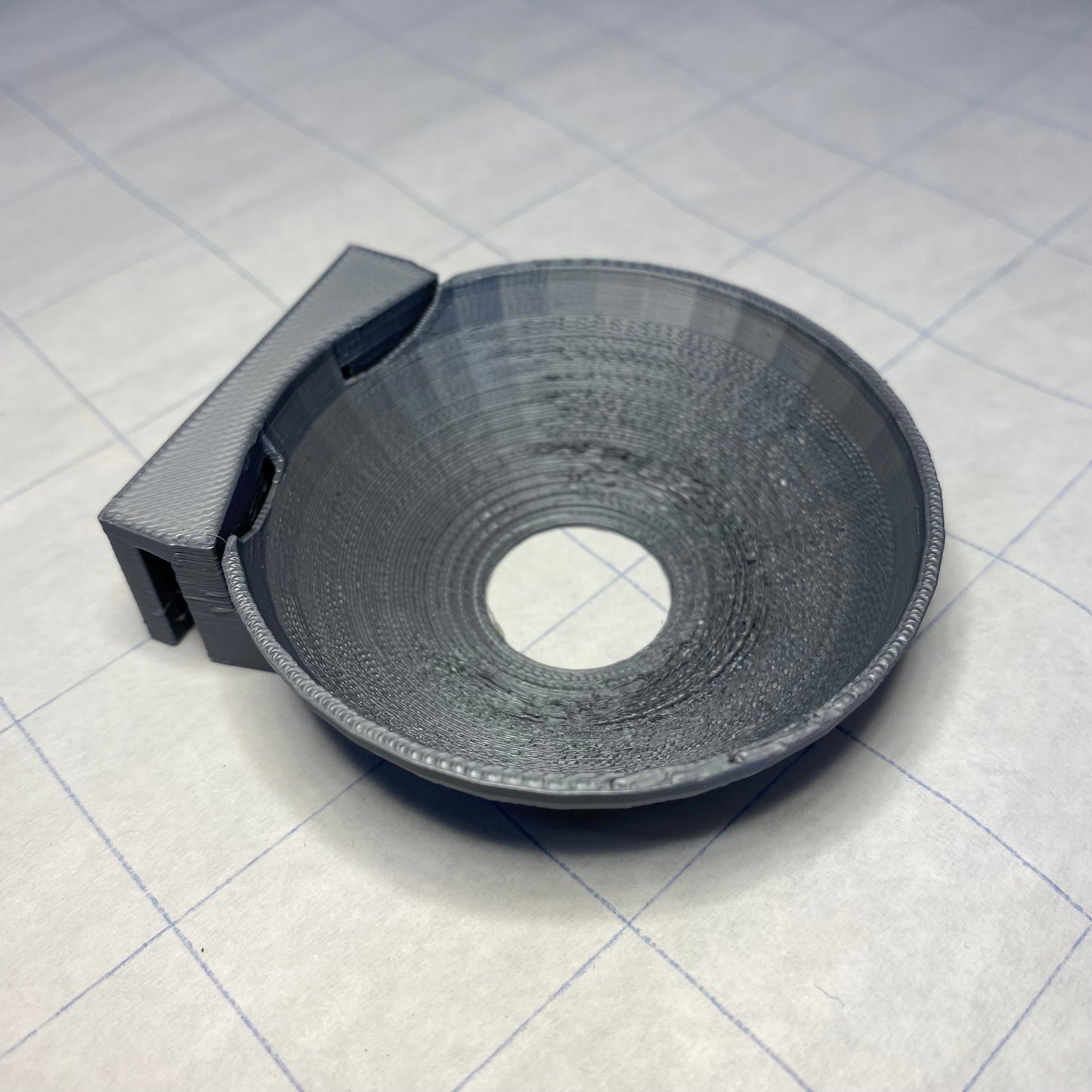 A 3D printable bowl that hangs on the back wall of the PinBox 3000